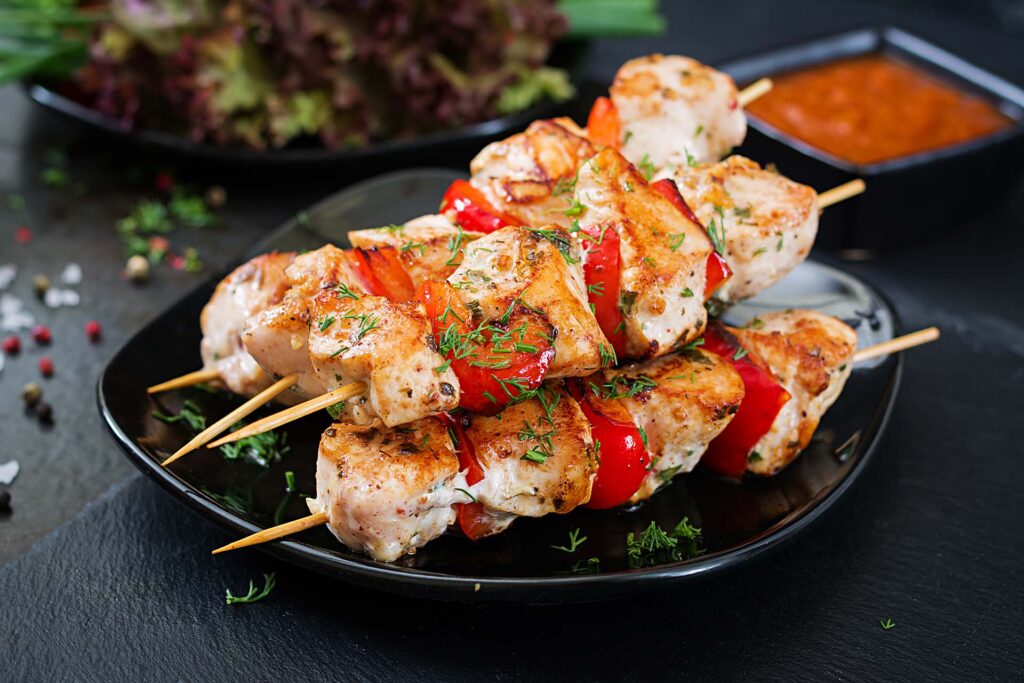 Chicken skewers with slices of sweet peppers and dill. Tasty foo