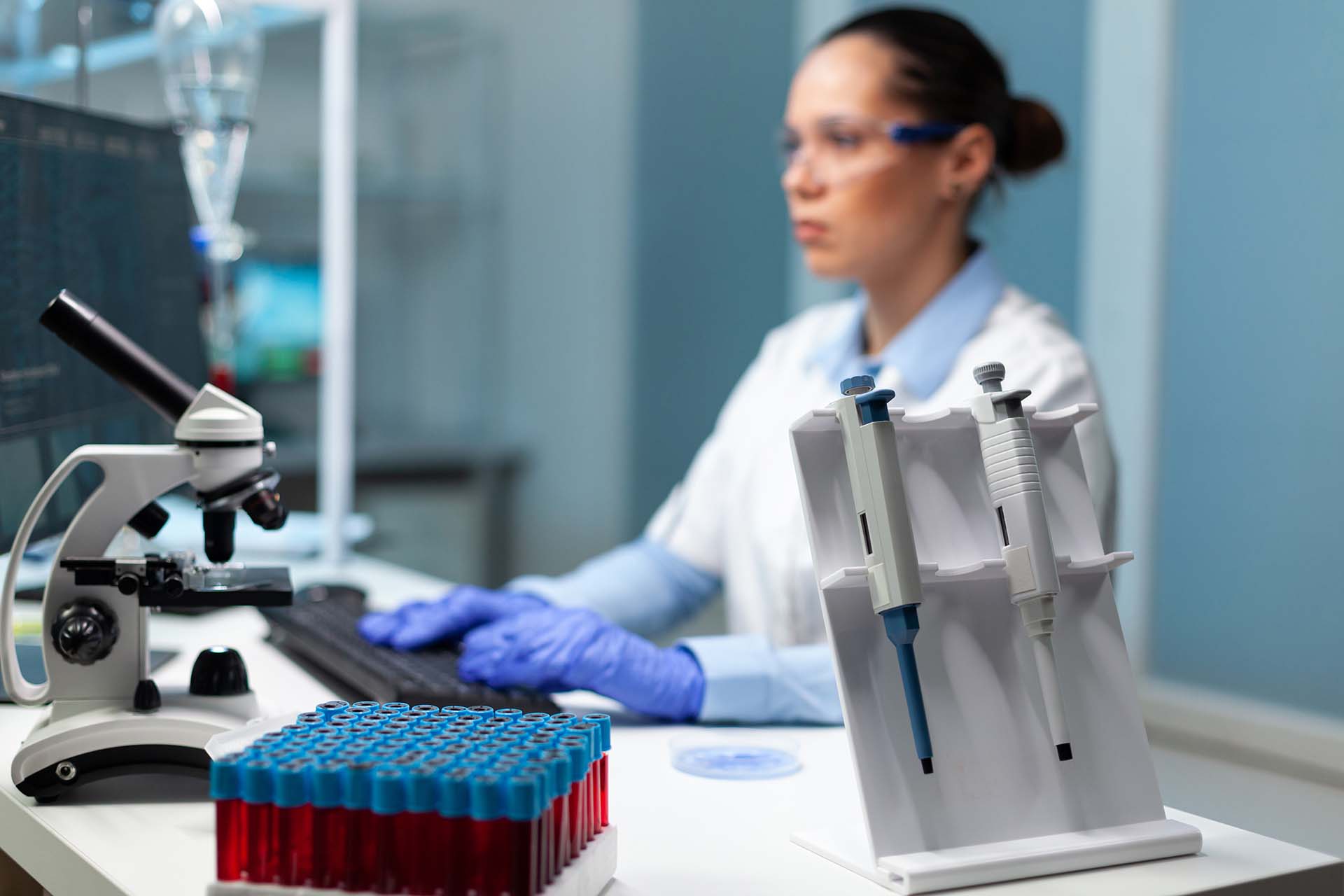 Biologist researcher woman with white coat discovering vaccine against virus